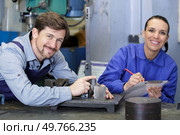 happy man and woman mechanics work with the appliance. Стоковое фото, агентство Ingram Publishing / Фотобанк Лори