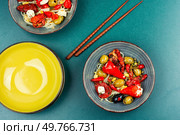 A delicious salad of pickled soybean sprouts, dried tomatoes, olives and peppers. Chinese food.. Vegan Salad of Pickled Vegetables and Soybeans. Стоковое фото, агентство Ingram Publishing / Фотобанк Лори