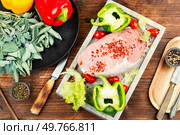 Spices on sliced raw pork meat, assorted raw meats for barbecuing on rustic wooden table.. A photo of raw pork on the table. Стоковое фото, агентство Ingram Publishing / Фотобанк Лори