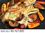 Appetizing fish of flounder cooked with fruits and vegetables. Seafood.. Tasty baked flatfish of flounder. Стоковое фото, агентство Ingram Publishing / Фотобанк Лори