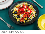Pickled soya bean salad with pickled soybean sprouts, dried tomatoes, olives and peppers. Korean Food.. Salad of preserved soy sprouts and pickled vegetables. Стоковое фото, агентство Ingram Publishing / Фотобанк Лори