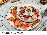Sweet and savory bacon wrapped dates served on a platter.. Gourmet bacon wrapped dates. Стоковое фото, агентство Ingram Publishing / Фотобанк Лори