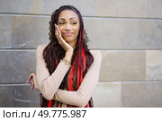 A confident woman with vibrant and eyecatching hair poses elegantly against a sleek, modern backdrop, radiating style and charm, showcasing her remarkable selfassurance and distinct individuality. A Stylish Woman is Posing with Unwavering Confidence in a Vibrant Urban Setting Environment. Стоковое фото, агентство Ingram Publishing / Фотобанк Лори