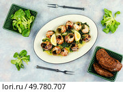 Snails baked with sauce, Bourgogne escargot snails, concept of french cuisine, gourmet food.. Baked snails with butter. Стоковое фото, агентство Ingram Publishing / Фотобанк Лори