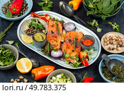 Uncooked, raw salmon and ingredients for cooking and seasoning on plate. Marinated salmon. Food photography.. Raw salmon steak and ingredients for cooking. Стоковое фото, агентство Ingram Publishing / Фотобанк Лори