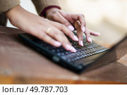 A closeup view of delicate and gentle hands gracefully typing on a sleek laptop, showcasing an enjoyable blend of creativity and productivity in a serene and peaceful setting that inspires work. Elegant Hands Gracefully Typing on a Modern Laptop Keyboard in a Focused Workspace Setting. Стоковое фото, агентство Ingram Publishing / Фотобанк Лори