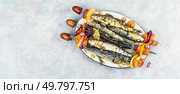 Baked sardines skewers. Fish kebabs, sardines on skewer, barbecue. Free space for your text.. BBQ Sardines and Vegetable Kabobs. Стоковое фото, агентство Ingram Publishing / Фотобанк Лори