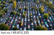 Rows of identical houses overflowing with unnecessary goods. Symbol of a major environmental problem caused by urban overconsumption waste. Abstract image. Стоковое AI-изображение, AI-художник ALLA YURTAYEVA / Фотобанк Лори