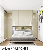 Compact bedroom with vertical bike mount and foldable bed system. 3d rendering.. Bedroom with foldable bed and vertical bike. Стоковое фото, агентство Ingram Publishing / Фотобанк Лори