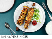 Skewers with fried young potatoes with bacon and cheese, picnic, kebab. Flat lay. Delicious kebab of bacon and potatoes. Стоковое фото, агентство Ingram Publishing / Фотобанк Лори