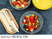 Pickled soya bean salad with pickled soybean sprouts, dried tomatoes, olives and peppers. Korean Food. Flat lay. Salad of preserved soy sprouts and pickled vegetables. Стоковое фото, агентство Ingram Publishing / Фотобанк Лори