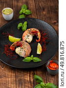 Traditional barbecue spiny lobster tail sliced and offered with saffron lemon sauce.. Broiled lobster tail, tasty steamed lobster. Стоковое фото, агентство Ingram Publishing / Фотобанк Лори