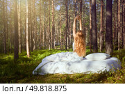 Woman sleeps on a mattress in the summer forest. Girl wakes up in a summer forest. Стоковое фото, агентство Ingram Publishing / Фотобанк Лори