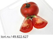 Cutting white plastic board with red tomato isolated on a white background. Стоковое фото, агентство Ingram Publishing / Фотобанк Лори