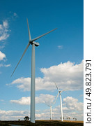 Wind turbines generating electricity with cloudy blue sky on the background. Стоковое фото, агентство Ingram Publishing / Фотобанк Лори