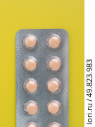 Macro view of medical pills on yellow background. Стоковое фото, агентство Ingram Publishing / Фотобанк Лори