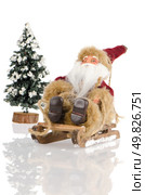 Miniature of Santa Claus on sleigh and a pine tree with snow, on white reflective background. Стоковое фото, агентство Ingram Publishing / Фотобанк Лори
