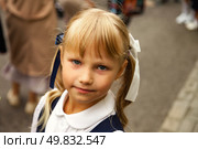 Joyful First-Grader With Pigtails Smiles Brightly on Her School Day Full of Excitement and Learning. Стоковое фото, фотограф Aleksandr Golubev / Фотобанк Лори