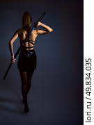 portrait of serious girl with katana. studio shot. Стоковое фото, агентство Ingram Publishing / Фотобанк Лори