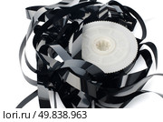 Pile of videotape reels on  white reflective background. Стоковое фото, агентство Ingram Publishing / Фотобанк Лори