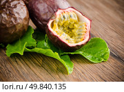 Passion fruits on wooden background. Стоковое фото, агентство Ingram Publishing / Фотобанк Лори