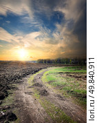 Sunset and country road through the plowed field. Стоковое фото, агентство Ingram Publishing / Фотобанк Лори