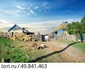 Firewoods near two old houses in the village . Стоковое фото, агентство Ingram Publishing / Фотобанк Лори