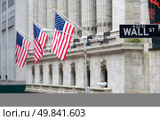 Wall street sign in New York with New York Stock Exchange background. Стоковое фото, агентство Ingram Publishing / Фотобанк Лори
