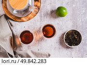 Earl Grey tea with bergamot in cups and teapot on table top view. Стоковое фото, фотограф Елена Руй / Фотобанк Лори