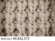 Beige knitted wool texture can use as background. Стоковое фото, агентство Ingram Publishing / Фотобанк Лори