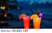 Tropical cocktails on the beach at night. Selective focus. Стоковое AI-изображение, AI-художник Васильева Юлия / Фотобанк Лори