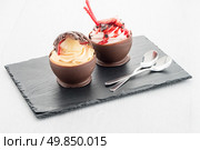 Tasteful strawberry and chocolate pastry mousse on black slate background. Стоковое фото, агентство Ingram Publishing / Фотобанк Лори