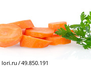 Pile of carrot slices closeup on white reflective background. Стоковое фото, агентство Ingram Publishing / Фотобанк Лори