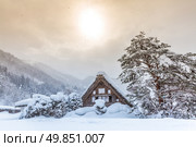 Shirakawago with Snowfall and winter Sun,  Gifu Chubu Japan. Стоковое фото, агентство Ingram Publishing / Фотобанк Лори