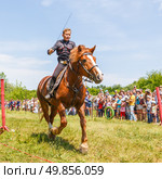 Russia, Samara, June 2016: A dashing Cossack on horseback during a demonstration performance at the Journey to the Past festival. Редакционное фото, фотограф Акиньшин Владимир / Фотобанк Лори