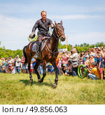 Russia, Samara, June 2016: A dashing Cossack on horseback during a demonstration performance at the Journey to the Past festival. Редакционное фото, фотограф Акиньшин Владимир / Фотобанк Лори