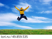 Man jump on the green meadow. Emotional scene. Стоковое фото, агентство Ingram Publishing / Фотобанк Лори
