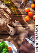 Top view of italian food on wooden table - bread, olive oil and tomatos with basil. Стоковое фото, агентство Ingram Publishing / Фотобанк Лори