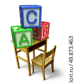 Primary education and early childhood learning with a school desk and basic letter blocks with a b and c representing childcare training of reading and writing skills. Стоковое фото, агентство Ingram Publishing / Фотобанк Лори
