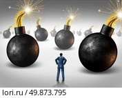 Dangerous challenge as a businessman conquering adversity as he decides on choices he faces as a concept of walking through a minefield as hazardous bombs with burning fuses ready to explode. Стоковое фото, агентство Ingram Publishing / Фотобанк Лори
