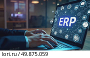 Manager analyzing data on an ERP system dashboard on a laptop. Concept of business process integration, corporate software for resource management, and workflow automation in a modern office. Стоковое AI-видео, аниматор Sergey Grishin / Фотобанк Лори