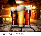 Three glasses of beer on a table in bar. Стоковое фото, агентство Ingram Publishing / Фотобанк Лори