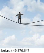 Risky choice business concept with a man walking a dangerous high wire tightrope that is in a crossroads splitting into two opposite directions as a symbol of strategy dilemma deciding on the best path. Стоковое фото, агентство Ingram Publishing / Фотобанк Лори