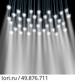 Stage lights as a group of shinning spotlights illuminating with bright beams of light to advertise and promote an important theatrical show event or product as a marketing and communication concept. Стоковое фото, агентство Ingram Publishing / Фотобанк Лори