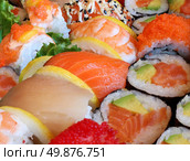 Japanese sushi close up with a variety of delicious prepared fresh raw fish and seafood as salmon shrimp and caviar with rice and vegetables as a food and drink concept of Asian cuisine and catering for a healthy Lifestyle. Стоковое фото, агентство Ingram Publishing / Фотобанк Лори