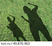 Bullying kids and school bully concept with the shadows of two children with one smaller child being threatened and abused by the older kid on green grass as a symbol of school safety from bullies. Стоковое фото, агентство Ingram Publishing / Фотобанк Лори