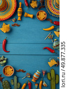 Colorful Fiesta Celebration Layout Featuring Hats, Snacks, and Drinks on Blue Wooden Table. Стоковое AI-изображение, AI-художник Юлия Гапеенко / Фотобанк Лори