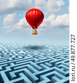 Rise above the challenges of business and life concept with a red hot air balloon with a businessman inside flying over a confusing maze or labyrinth puzzle as a metaphor for conquering adversity success with leadership. Стоковое фото, агентство Ingram Publishing / Фотобанк Лори