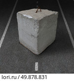 Roadblock obstacle and barrier business concept with a huge cement or concrete cube barricade blocking a road or highway as a symbol of restricted opportunity or political gridlock resulting in government or financial system shutdown. Стоковое фото, агентство Ingram Publishing / Фотобанк Лори