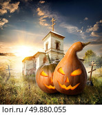 Halloween pumpkins on a churchyard near old church. Стоковое фото, агентство Ingram Publishing / Фотобанк Лори